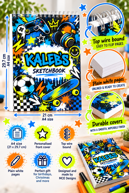 A colorful spiral sketchbook with a vibrant sports-themed cover design featuring a soccer ball, skateboard, and game controller. The image includes multiple callout graphics and text highlighting features such as top wire binding, plain white pages, and durable covers, along with dimensions of 23.